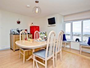 Dining area has views across the harbour and seating for six guests.